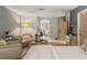 Cozy main bedroom with seating area and ensuite bathroom entrance at 3320 Pattie Pl, Palm Harbor, FL 34685