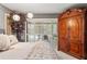 Bright main bedroom with a view of the pool through shuttered glass doors at 3320 Pattie Pl, Palm Harbor, FL 34685