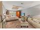 Spacious main bedroom with tray ceilings, sitting area, and ample natural light at 3320 Pattie Pl, Palm Harbor, FL 34685