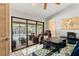 Bright office features a glass top desk and massage chair with access to a screened-in porch and pool at 3320 Pattie Pl, Palm Harbor, FL 34685