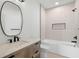 Bathroom featuring tile shower, a built-in niche, wood vanity, and a toilet at 4166 38Th S St, St Petersburg, FL 33711