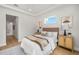 Bedroom featuring a large window, white bedding, and a decorative rug at 4166 38Th S St, St Petersburg, FL 33711