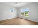 Bright bedroom featuring wood floors, a ceiling fan, and natural light from two windows at 4166 38Th S St, St Petersburg, FL 33711