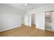 This is a light, bright bedroom that features wood floors and an open door to the bathroom at 4166 38Th S St, St Petersburg, FL 33711