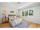 Bedroom features large windows, white bedding, and light wood floors, and a decorative rug at 4166 38Th S St, St Petersburg, FL 33711