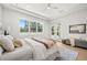 Bright bedroom with a large window, white bedding, and light wood floors at 4166 38Th S St, St Petersburg, FL 33711