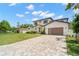 A long driveway leads to a modern two-story home with a well-maintained lawn at 4166 38Th S St, St Petersburg, FL 33711