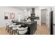 Elegant kitchen with stainless steel appliances, a black countertop island, and seating at 4166 38Th S St, St Petersburg, FL 33711