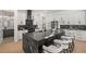 Modern kitchen with a large island, white cabinets, and elegant black countertops at 4166 38Th S St, St Petersburg, FL 33711