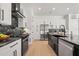 Modern kitchen featuring black countertops, a black backsplash, and stainless steel appliances at 4166 38Th S St, St Petersburg, FL 33711
