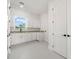 Bright laundry room features white cabinets, granite countertops, and a window for natural light at 4166 38Th S St, St Petersburg, FL 33711