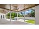 A covered patio features wood ceilings, recessed lights, and fans, perfect for outdoor enjoyment near the pool at 4166 38Th S St, St Petersburg, FL 33711