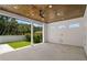 Covered outdoor patio with a wooden ceiling, fan, and an open view to the backyard at 4166 38Th S St, St Petersburg, FL 33711