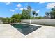 Modern rectangular pool with stone coping, surrounded by lush landscaping, provides a private oasis at 4166 38Th S St, St Petersburg, FL 33711