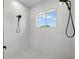 This shower features dual shower heads and a window at 4166 38Th S St, St Petersburg, FL 33711