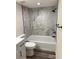Updated bathroom with marble wall, black fixtures, and white vanity with modern design at 4212 Pasadena Cir, Sarasota, FL 34233