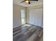 Bedroom with laminate flooring, window, and a closet with sliding doors at 4212 Pasadena Cir, Sarasota, FL 34233