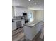 Modern kitchen featuring white cabinets, stainless steel appliances, and a granite-topped island at 4212 Pasadena Cir, Sarasota, FL 34233
