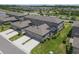 This aerial view captures the home's attached two-car garage and screened lanai, complemented by landscaping at 4639 Bexley Village Dr, Land O Lakes, FL 34638