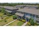 Aerial view features roof lines, landscaping and backyard screened patio space at 4639 Bexley Village Dr, Land O Lakes, FL 34638