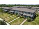 Aerial view of townhomes showcasing layout, landscaping, and community setting at 4639 Bexley Village Dr, Land O Lakes, FL 34638