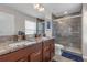 Elegant bathroom boasting dual sinks, granite countertops, a walk-in shower, and modern fixtures at 4639 Bexley Village Dr, Land O Lakes, FL 34638
