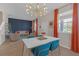 Elegant dining area with a modern chandelier, stylish furniture, and bright natural light at 4639 Bexley Village Dr, Land O Lakes, FL 34638