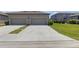Spacious two-car driveway leading to an attached garage, with manicured landscaping at 4639 Bexley Village Dr, Land O Lakes, FL 34638