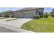 Long driveway leading to attached garage, framed by well-maintained lawns at 4639 Bexley Village Dr, Land O Lakes, FL 34638