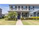 Charming two-story home featuring a covered front porch, decorative shutters, and a manicured lawn at 4639 Bexley Village Dr, Land O Lakes, FL 34638