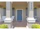 Charming covered front porch with seating area and welcoming entryway at 4639 Bexley Village Dr, Land O Lakes, FL 34638