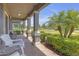 Inviting front porch with brick flooring, stylish columns, and comfortable seating area at 4639 Bexley Village Dr, Land O Lakes, FL 34638