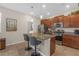 Well-appointed kitchen features an island with seating, stainless appliances, and seamless access to the laundry room at 4639 Bexley Village Dr, Land O Lakes, FL 34638