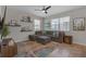 Cozy living room with comfortable seating, a ceiling fan, floating shelves, and plenty of natural light at 4639 Bexley Village Dr, Land O Lakes, FL 34638