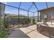Relaxing screened patio with hanging chair and brick-paved floor at 4639 Bexley Village Dr, Land O Lakes, FL 34638