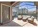 Screened patio area with brick flooring and comfortable seating arrangement at 4639 Bexley Village Dr, Land O Lakes, FL 34638