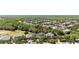 The overhead view focuses on the house nestled within a community surrounded by mature trees at 5313 Sanderling Ridge Dr, Lithia, FL 33547
