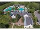 Aerial view of the neighborhood clubhouse and community pools surrounded by greenery at 5313 Sanderling Ridge Dr, Lithia, FL 33547