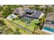 Aerial view of the home showcases a spacious backyard with a screened-in pool and well-manicured lawn at 5313 Sanderling Ridge Dr, Lithia, FL 33547