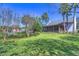 Expansive backyard with lush green lawn, screened porch, and a view of the pool area, perfect for outdoor enjoyment at 5313 Sanderling Ridge Dr, Lithia, FL 33547