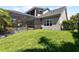 This image highlights a meticulously maintained backyard featuring a screened-in pool and lush green grass at 5313 Sanderling Ridge Dr, Lithia, FL 33547