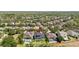 Aerial view of a backyard featuring a sparkling pool, well-maintained lawn, and a screened-in patio area at 5313 Sanderling Ridge Dr, Lithia, FL 33547