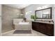 Well-lit bathroom features a tiled shower and bathtub with vanity and granite countertops at 5313 Sanderling Ridge Dr, Lithia, FL 33547