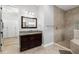 Elegant bathroom featuring granite vanity, framed mirror, and tiled shower with glass door at 5313 Sanderling Ridge Dr, Lithia, FL 33547