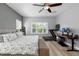 Bedroom with hardwood floors, a ceiling fan, and large windows that let in plenty of natural light at 5313 Sanderling Ridge Dr, Lithia, FL 33547