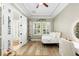 Bright bedroom with wood floors, tray ceiling, large windows, a desk and sports decor at 5313 Sanderling Ridge Dr, Lithia, FL 33547