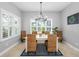 Dining room with large windows, a modern chandelier, and seating for six at 5313 Sanderling Ridge Dr, Lithia, FL 33547