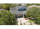 The image shows a beautiful two-story home with an attached two car garage, surrounded by mature trees at 5313 Sanderling Ridge Dr, Lithia, FL 33547