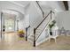 Elegant foyer with tile floors, decorative lighting, and a staircase leading to the upper level at 5313 Sanderling Ridge Dr, Lithia, FL 33547