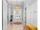 Bright foyer featuring tile floors, decorative lighting, and a sliding door leading to additional rooms at 5313 Sanderling Ridge Dr, Lithia, FL 33547